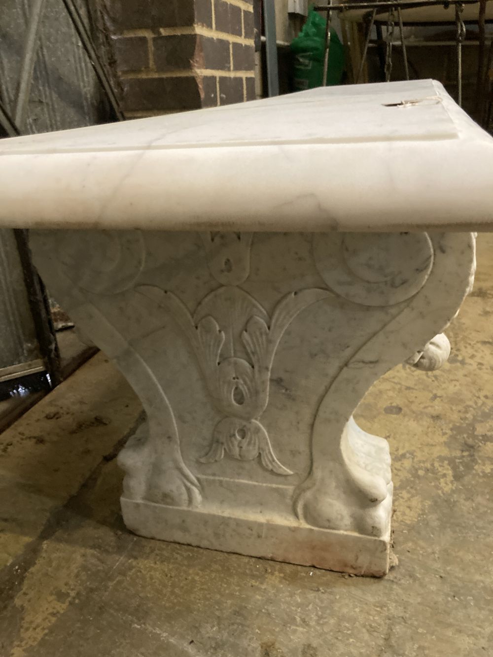 An early 20th century Italian carved white marble bench, with later marble top, width 182cm depth 45cm height 48cm